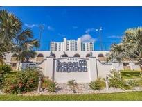 Attractive building entrance showcasing lush landscaping and the Beau Monde sign at 4950 Gulf Blvd # 409, St Pete Beach, Fl, FL 33706