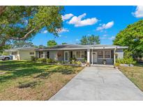 Charming single story home featuring a well-manicured lawn, a concrete driveway, and flower boxes under the front windows at 707 24Th Sw St, Largo, FL 33770