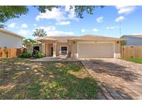 Charming single-story home with a two-car garage, paved driveway, and a well-maintained front yard at 10310 Salisbury St, Riverview, FL 33569