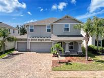 Charming two-story home featuring a three-car garage, paver driveway, and well-manicured landscaping at 10560 Lake Seminole Ter, Seminole, FL 33772