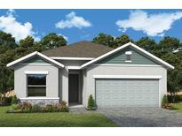 Charming single-story home featuring a two-car garage, beautiful landscaping, and a welcoming entrance at 10657 Crescent Creek Xing, Parrish, FL 34219