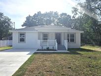Charming single-story home with a freshly painted exterior and well-manicured front lawn at 21033 Market St, Dade City, FL 33523