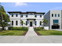 Stunning two-story home with black trim, elegant landscaping, and a welcoming entrance at 403 E Davis Blvd, Tampa, FL 33606