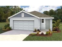 Charming single-story home with a two-car garage, landscaped yard, and a welcoming front entrance at 1010 Spotted Egret Loop, Ruskin, FL 33570