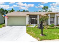 Charming single-story home featuring a well-manicured lawn and inviting front entrance at 11148 Hollander Ave, Hudson, FL 34667