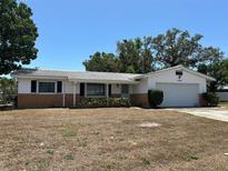 Charming single-story home featuring a combination brick and siding exterior, plus an attached garage and drought resistant yard at 11198 58Th Ave, Seminole, FL 33772