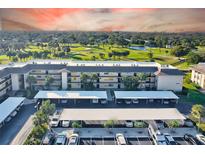 A condo building with covered parking and a golf course view at 12300 Vonn Rd # 7107, Largo, FL 33774