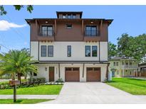 Striking, modern two-story home with a two-car garage, balconies, and professionally landscaped yard at 2200 N Glenwood Dr, Tampa, FL 33602