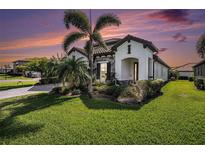 Beautiful single-story home boasts lush lawn, stone accents, and a well-manicured landscape at 2515 63Rd Ter E, Ellenton, FL 34222