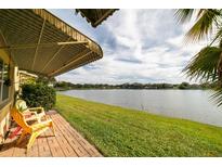 Outdoor patio with red brick and lawn views of the water and community landscape under an awning at 3850 13 N Ave # 113, St Petersburg, FL 33713