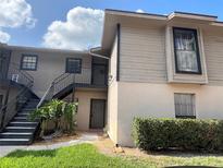 Inviting two-story condo with well-maintained landscaping and convenient stair access to the entrance at 4008 Ashford Green Pl # F101, Tampa, FL 33613