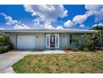 Charming single-story home with well-maintained lawn and a decorative front door at 5480 Orange Blossom N Rd, Pinellas Park, FL 33782