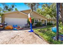 Charming single Gathering home featuring a well-manicured lawn and a two-car garage in a suburban setting at 577 Waterfall Dr, Spring Hill, FL 34608