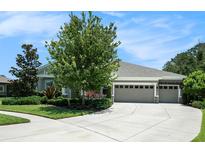 Charming single-story home featuring an attached two car garage and beautifully landscaped front yard at 8016 Rock Spring Ct, Land O Lakes, FL 34638