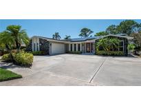 Charming single-story home featuring a circular driveway and a two-car garage at 1907 Sandpiper Dr, Clearwater, FL 33764