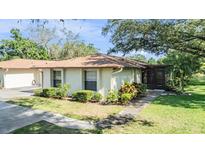 Charming single-story home features well-maintained landscaping and a welcoming entrance at 2150 Shelly Dr # D, Palm Harbor, FL 34684
