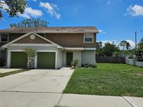 Charming townhome featuring an attached two-car garage and a well-maintained front lawn at 5101 Corvette Dr, Tampa, FL 33624