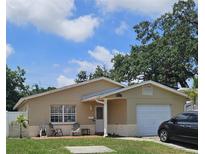 Charming single-story home with a well-manicured lawn, front patio seating, and a one-car garage at 5542 19Th N Ave, St Petersburg, FL 33710