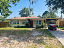 Charming single-story home with a well-maintained yard and convenient golf cart parking at 5805 Tennessee Ave, New Port Richey, FL 34652