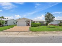 Charming single-story home with well-manicured lawn, brick driveway, and attached one car garage at 9226 41St N St, Pinellas Park, FL 33782