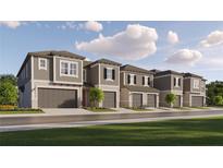 Charming townhomes feature neutral exteriors, individual garages, and beautifully maintained front yards at 10808 Keato Beach Ct, Tampa, FL 33647