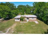 Charming single-story home with a rock detail, mature trees, and a well-maintained lawn at 2015 Pleasant Acre Dr, Plant City, FL 33566
