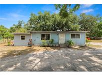 Charming single-story home with light blue siding and mature trees in the front yard at 2504 Jim Johnson Rd, Plant City, FL 33566