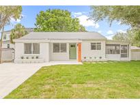Charming single-story home with a well-maintained lawn and freshly painted white brick exterior at 3008 W Van Buren Dr, Tampa, FL 33611