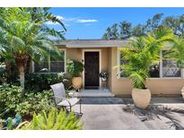 Charming home featuring a beautiful, intricately designed front door surrounded by lush landscaping at 3626 S Hesperides St, Tampa, FL 33629