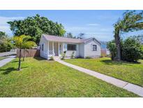 Charming single-story home featuring a well-maintained lawn and inviting walkway at 4000 Grove S St, St Petersburg, FL 33705