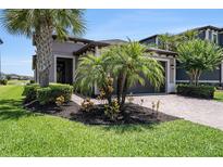 Beautiful single-Gathering home with manicured lawn, paver driveway, and lush landscaping at 4652 San Martino Dr, Wesley Chapel, FL 33543