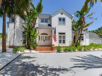 Charming two-story home with landscaped yard and inviting entryway, complemented by tropical landscaping at 4702 W Heron Ln, Tampa, FL 33629