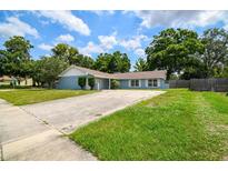 Charming single-story home with a well-manicured lawn, long driveway and mature trees at 509 Stone Dr, Brandon, FL 33510