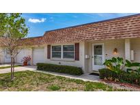 Charming single-story home featuring a well-maintained lawn, attached garage, and cozy front entrance at 602 Mindy Dr, Largo, FL 33771