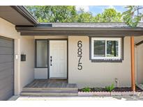 Charming home featuring a well-lit front door and stylish house numbers at 6875 11Th N Ave, St Petersburg, FL 33710