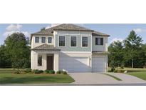 Two-story home featuring a two-car garage, manicured lawn, and a charming covered porch at 9376 Gladsome Dr, Land O Lakes, FL 34637
