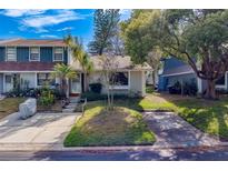 Charming townhome with mature trees, inviting landscaping and a private driveway at 1249 Abbey Crescent Ln, Clearwater, FL 33759
