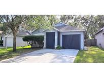 Charming single-Gathering home with a two-car garage and well-maintained landscaping, offers curb appeal and convenience at 15124 Deer Meadow Dr, Lutz, FL 33559