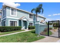 Inviting two-story townhouse featuring a private entrance, manicured lawn, and secure gated entry at 1603 Fluorshire Dr, Brandon, FL 33511