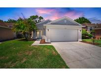 Charming single-Gathering home featuring a well-maintained lawn, two-car garage and inviting curb appeal at 26501 Whirlaway Ter, Wesley Chapel, FL 33544