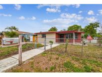 Charming single-story home featuring a fenced yard and a welcoming walkway to the front entrance at 3324 W Saint Joseph St, Tampa, FL 33607