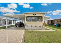 Charming single-story home featuring well-maintained lawn and covered parking at 37105 Lois Ave, Zephyrhills, FL 33542