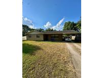 Charming single-story home featuring a brick facade, covered parking, and a spacious front yard at 7620 32Nd S Ave, Tampa, FL 33619