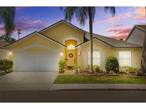 Charming single-Gathering home featuring a two-car garage, well-manicured lawn, and attractive curb appeal at 8820 Cypress Hammock Dr, Tampa, FL 33614