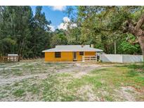 Charming one-story home featuring a fenced yard and inviting front porch at 8828 Jasmine Blvd, Port Richey, FL 34668