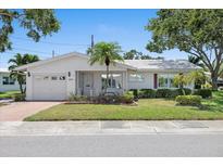 Charming single-story home with well-manicured lawn, front porch, and attached garage at 9690 41St N St # 0, Pinellas Park, FL 33782