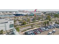 Aerial view of harbor featuring cruise ships docked near the terminal and sprawling parking lots at 101 N 12Th St # 400, Tampa, FL 33602