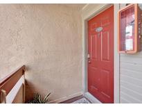 Inviting unit entrance with a red front door and a visible unit number at 10265 Gandy N Blvd # 906, St Petersburg, FL 33702