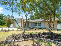 Charming single-story home with fresh landscaping, inviting curb appeal, and a well-manicured front yard at 2433 Blind Pond Ave, Lutz, FL 33549