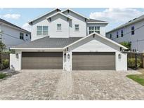 Beautiful exterior of home featuring a brick driveway and attached two-car garages at 307 S Arrawana Ave # 100, Tampa, FL 33609